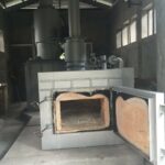 a large metal oven with a chimney inside