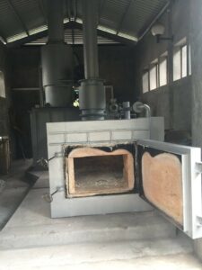 a large metal oven with a chimney inside