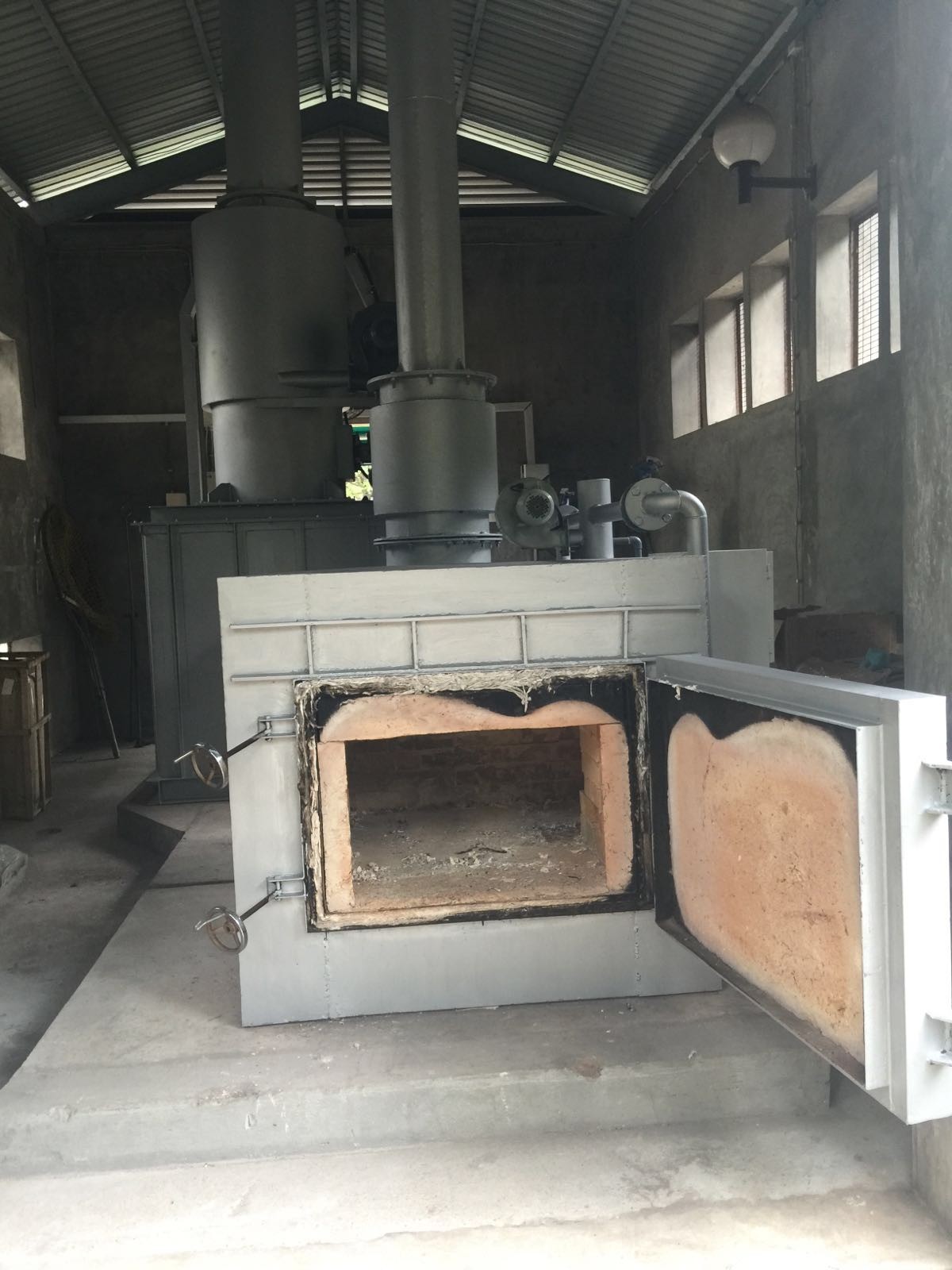 a large metal oven with a chimney inside